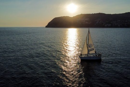 Sailing at sunset along the cliffs of Maro-Compartida
